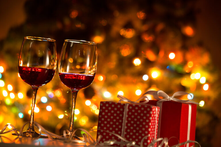 Crystal,Glasses,Of,Wine,And,Christmas,Gifts,On,The,Background