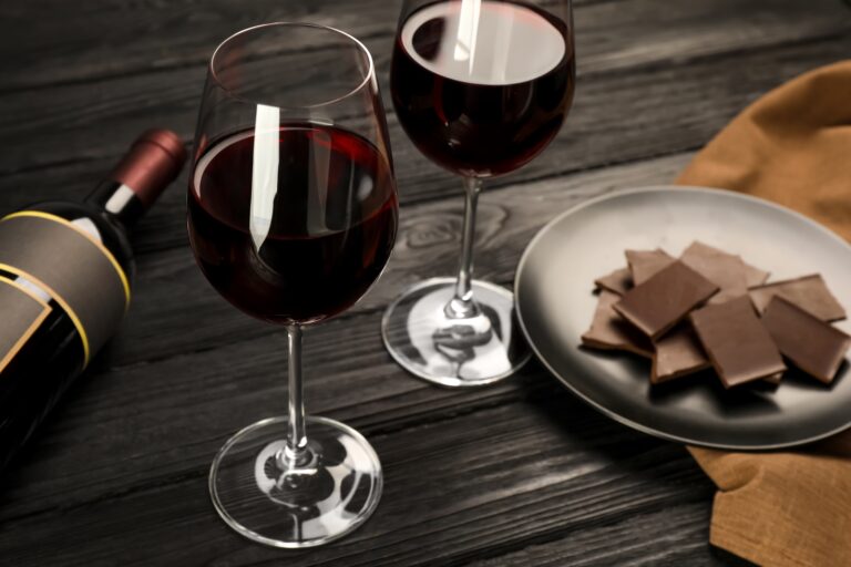 Tasty,Red,Wine,And,Chocolate,On,Black,Wooden,Table